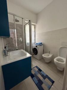 y baño con lavabo, aseo y lavadora. en Grazioso bilocale Da Zia Bruna, en Vallecrosia