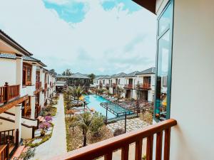 a view of the pool from a balcony at a resort at Palm Bay Resort Phu Quoc in Phú Quốc