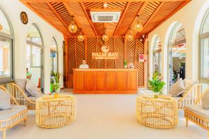 a lobby with chairs and a bar in a store at Palm Bay Resort Phu Quoc in Phú Quốc