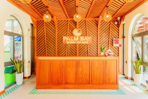 a wooden entrance to a pharmacy with a sign on the wall at Palm Bay Resort Phu Quoc in Phú Quốc