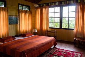 a bedroom with a large bed and two windows at Wattarantanne homestay in Kandy +103 photos