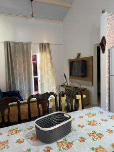 a living room with a table with a table cloth on it at Chalé em Resort in Mairinque