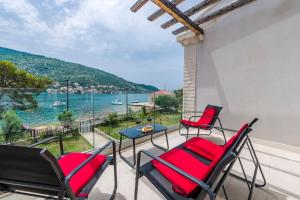 a balcony with chairs and a table with a view of the water at Mariva Dubrovnik in Mokošica