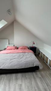 a bedroom with a large bed in a attic at Au petit alveo in Sprimont