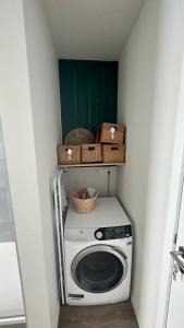 a washing machine with baskets on top of it at Au petit alveo in Sprimont
