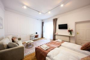 a living room with a large bed and a couch at Wiślna Main Square Apartments in Krakow