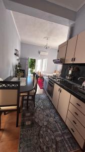 a kitchen with a table and a dining room at Priam Garden in Durrës +9 photos