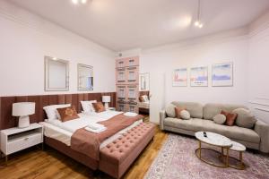a bedroom with a bed and a couch at Wiślna Main Square Apartments in Krakow