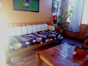 a bedroom with a bed in a room with a table at Cabaña Onty in El Calafate