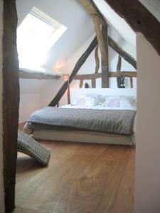 a bedroom with a bed in an attic at Domaine de la Folicoeur in Sainte-Colombe-près-Vernon