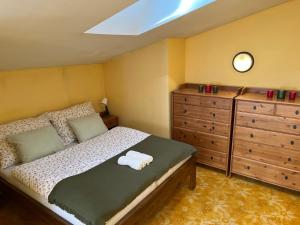 a bedroom with a bed with a dresser and a mirror at Apartmán Z.E.M. 
