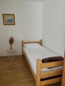 a bedroom with a bed and a table in a room at Secret Place Apartment in Stari Grad