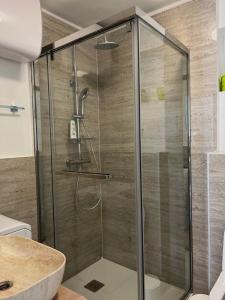 a shower with a glass door in a bathroom at Secret Place Apartment in Stari Grad