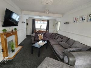 a living room with a couch and a flat screen tv at 3 bedroom house in Grays Thurrock