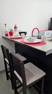 een keuken met een aanrecht met 2 stoelen en een wastafel bij EcoStudio in San José