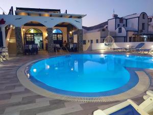 a large swimming pool in the middle of a resort at Georgia's Comfort Studio in Perivolos