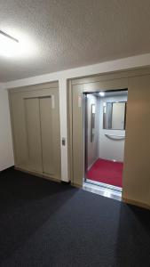 una stanza vuota con una porta e un tappeto rosso di Appartement pied des pistes - Samoëns 1600 a Samoëns