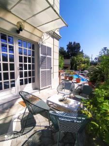 a group of chairs and a table on a patio at Pergolato suite in Sanremo