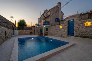 a swimming pool in a yard with a house at House AnaDora with pool - Zlarin in Zlarin