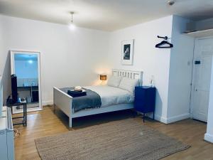 a bedroom with a bed and a room with a mirror at HAGGERSTON in London