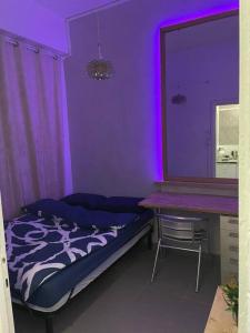 a purple room with a bed and a desk at Peaceful and intimate by the sea in Haifa