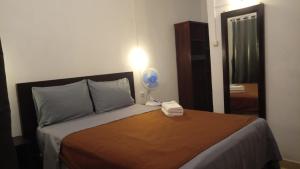 a bedroom with a bed with a fan on it at Hotel Arda Bali in Negara