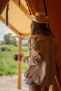 a woman wearing a cowboy hat standing in a tent at Teton Peaks Resort in Tetonia