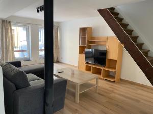 a living room with a couch and a table at L'Harmonie de Wavre in Wavre