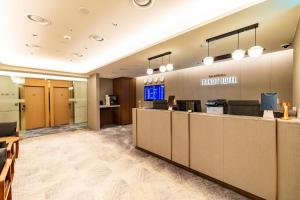 an office lobby with a trial tool sign on the wall at Incheon Airport Transit Hotel Terminal 1 in Incheon