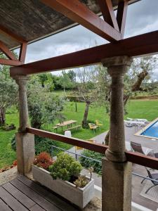 a porch with a view of a yard and a pool at Casa Branca in Covas