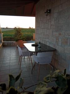 a patio with a table and two chairs and a view at Rodiola House in Afitos