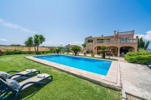a house with a swimming pool in the yard at Ideal Property Mallorca - Villa Gomila in Sa Pobla