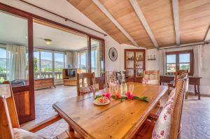 a dining room with a wooden table with flowers on it at Ideal Property Mallorca - Villa Gomila in Sa Pobla