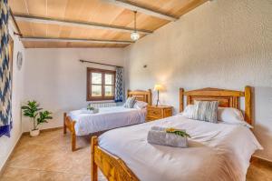a bedroom with two beds and a window at Ideal Property Mallorca - Villa Gomila in Sa Pobla