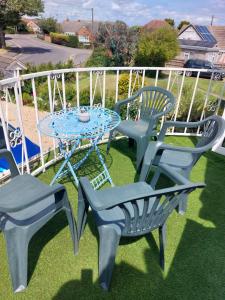 a patio table and chairs on a balcony at Sea Air B&B in Chapel Saint Leonards