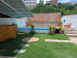 a small yard with a swimming pool in a backyard at The Best Adventure Hostel in San Gil