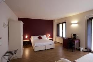 Postel nebo postele na pokoji v ubytování Hotel Leon D'Oro