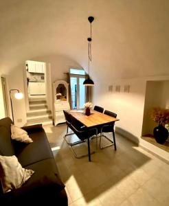 a living room with a table and a couch at Casa di Vincenzo in Airole