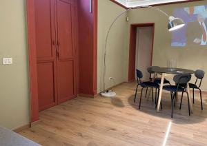 a room with a table and chairs and a lamp at Beauty Apartment in Catania +3 photos