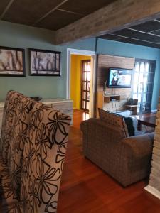 a living room with a couch and a tv at Delightful Home in Pretoria