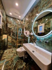 a bathroom with a sink and a mirror at Christine Studios in Poros