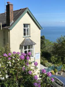 a house with purple flowers in front of it at North Walk House in Lynton