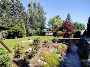 a garden with a bridge and a stream at Studio 45 sqm with mountain view in Porumbacu de Sus +8 photos