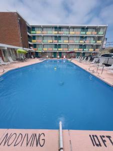 a large swimming pool in front of a building at Skyview Manor Motel in Seaside Heights