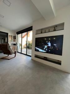 a living room with a large flat screen tv on a wall at Apartment Stari Pazar 2 in Konjic