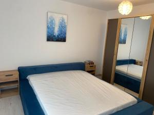 a small bedroom with a bed and a mirror at Sweet Home Sibiu in Sibiu