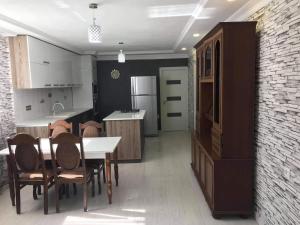 a kitchen with a table and chairs and a refrigerator at Nino's Holiday guesthouse in Borjomi