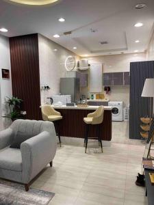 a kitchen with a couch and chairs in a room at دور أرضي بتصميم فاخر دخول ذاتي in Riyadh