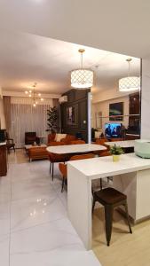 a living room with a white table and chairs at 3Br Sky House BSD Apartment Brandnew and Cozy in Samporo