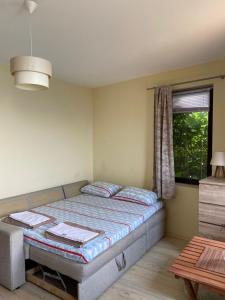 a small bedroom with a bed and a window at Apartment in a beach house Old town Nessebar in Nesebar